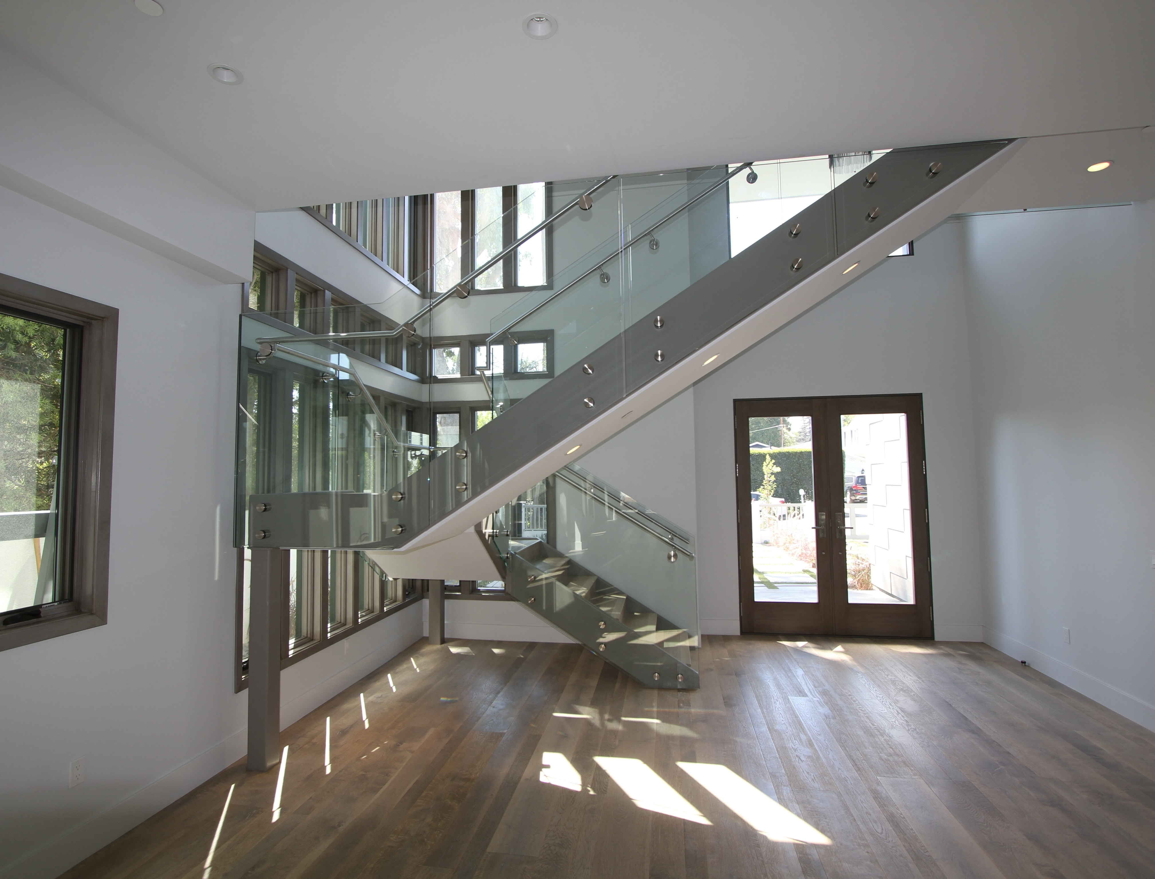 Custom glass staircase railing project by DC Glass