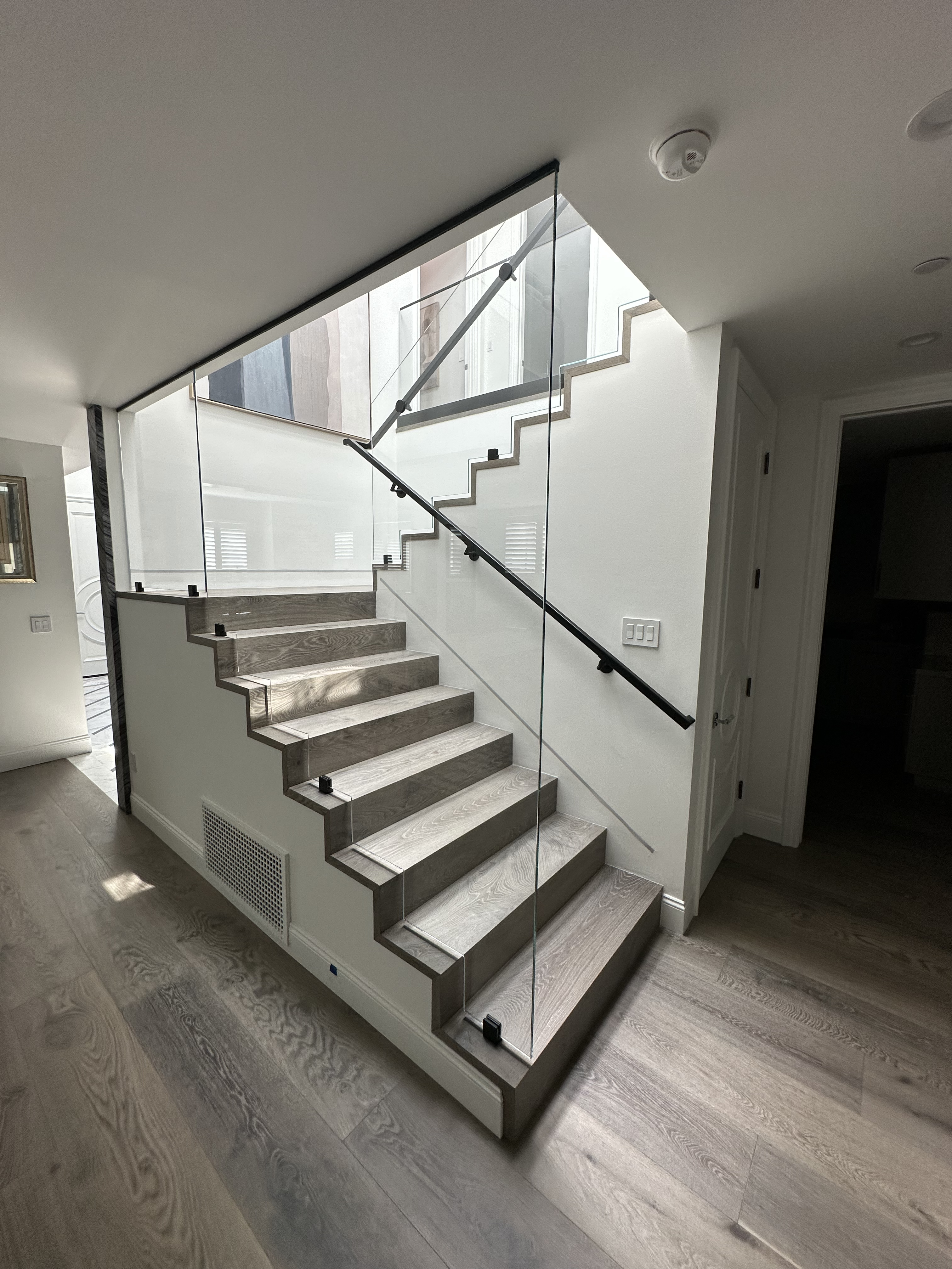 Glass staircase railing installation by DC Glass